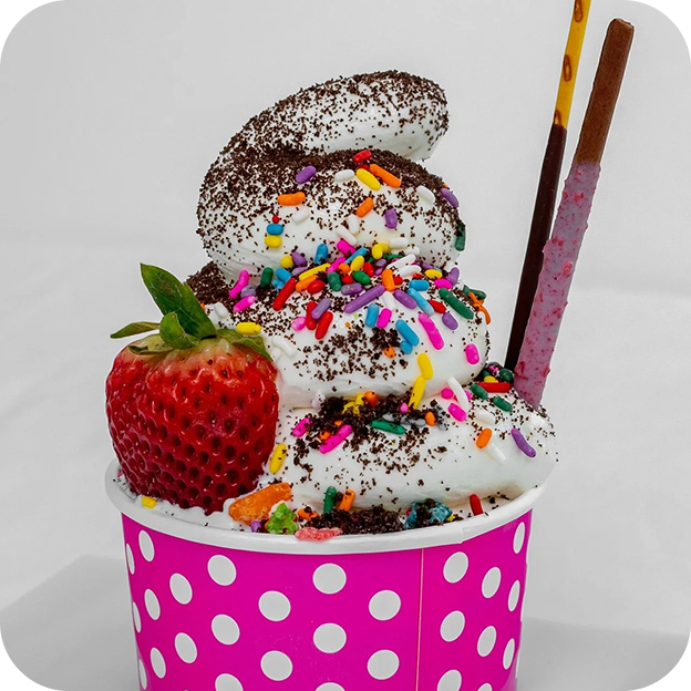 Colorful frozen yogurt with toppings and fresh strawberry